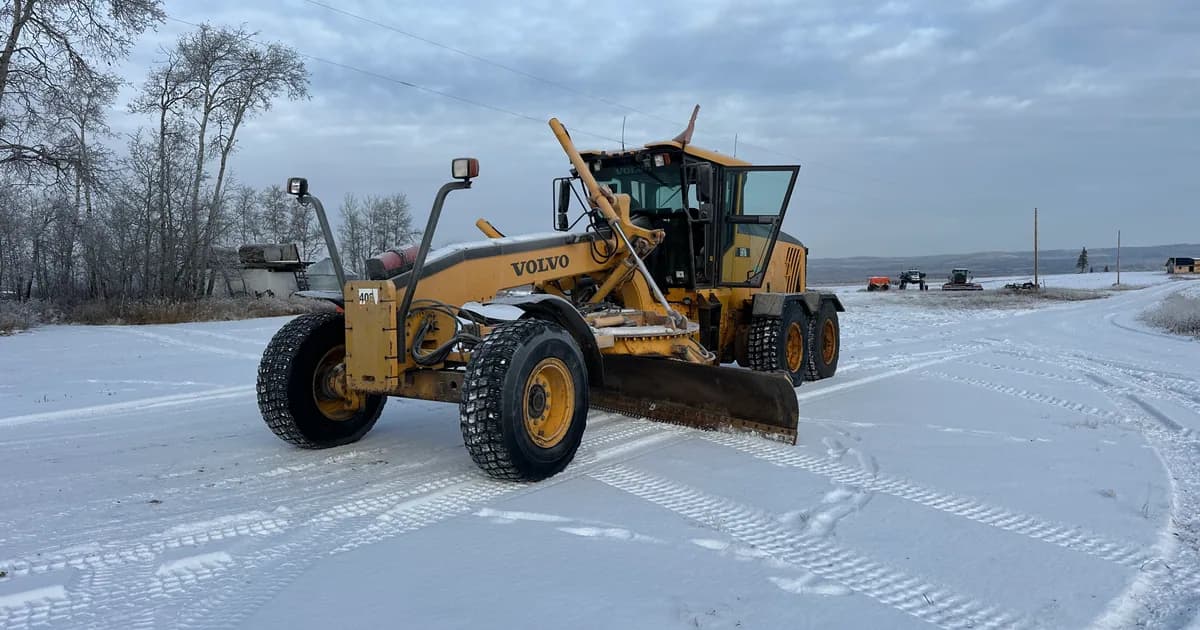 2012 Volvo G976 grader with snow wing — common lease-or-finance decision unit